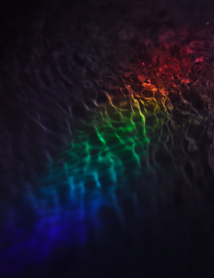 Vibrant rainbow light reflections creating an abstract art pattern.